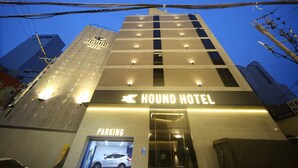 The exterior of the Hound Hotel with a visible entrance and a parking sign. - Hound Hotel Sajik Minam Station (Busan)