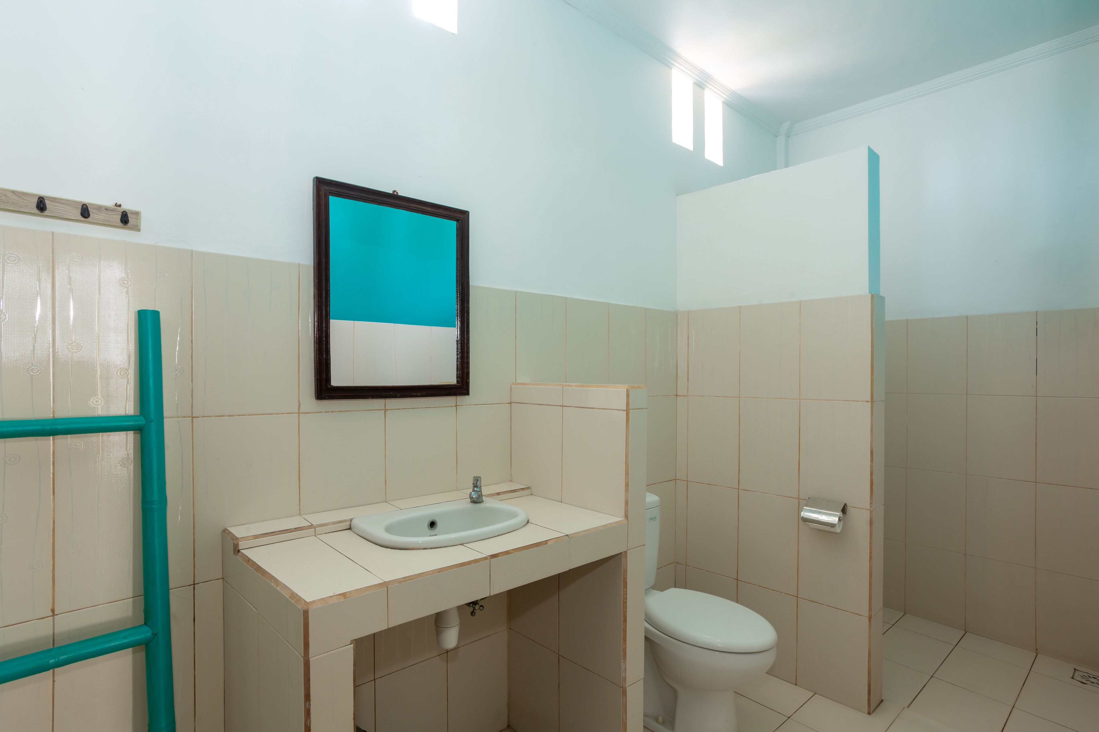 A bathroom with a sink, toilet, and shower area.