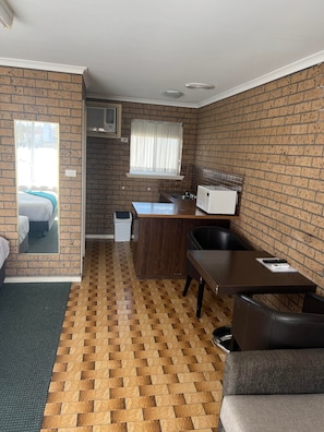 Basic Studio, Multiple Beds | Living area | 32-inch TV with digital channels