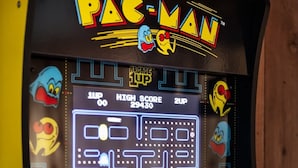 A Pac-Man arcade game with a maze display, score counter, and coin-operated controls. - Far View Shenandoah | Hot Tub, Movie & Game Room, Valley Views | 3BR & Sleeps 6 (Front Royal)