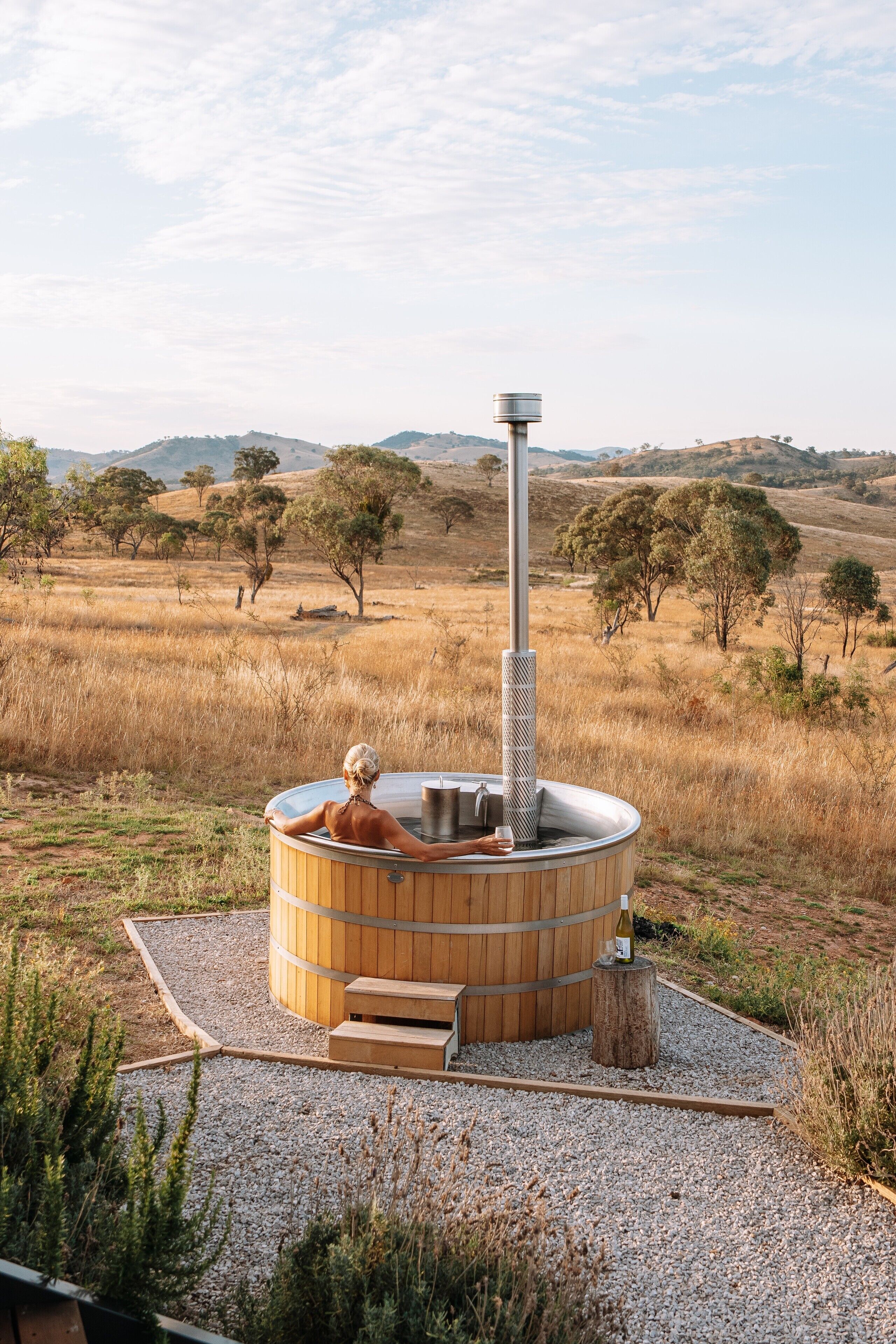 A hot tub in a natural setting with a clear view of the surrounding landscape.