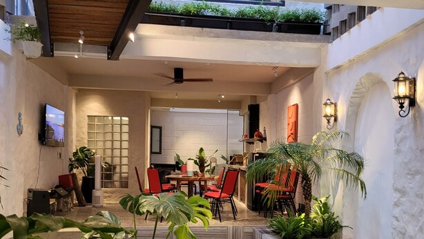 Un grand espace intérieur comprenant une piscine, un coin salon et un espace repas.