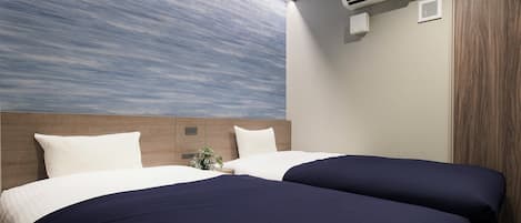 A hotel room with two beds, a large window with a view, an air conditioning unit, and a wooden door.