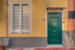 Stylish building with a central entrance and a window with horizontal blinds.