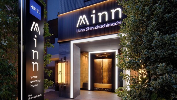 A hotel entrance with a prominent 'Minn' sign and a vertical sign stating 'your second home'. - Minn Ueno Shin-Okachimachi (Tokyo)