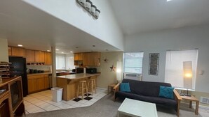 A compact living space with a kitchenette, a sofa, and a coffee table. - *Sunland Estates* Stunning property (Quincy)
