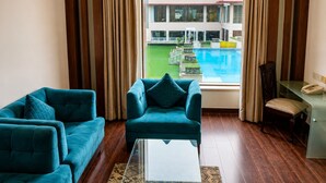A hotel room with a view of a swimming pool and a building complex. - Bel-La Monde Hotel NH8 at 6km from IGI Airport Delhi (New Delhi)