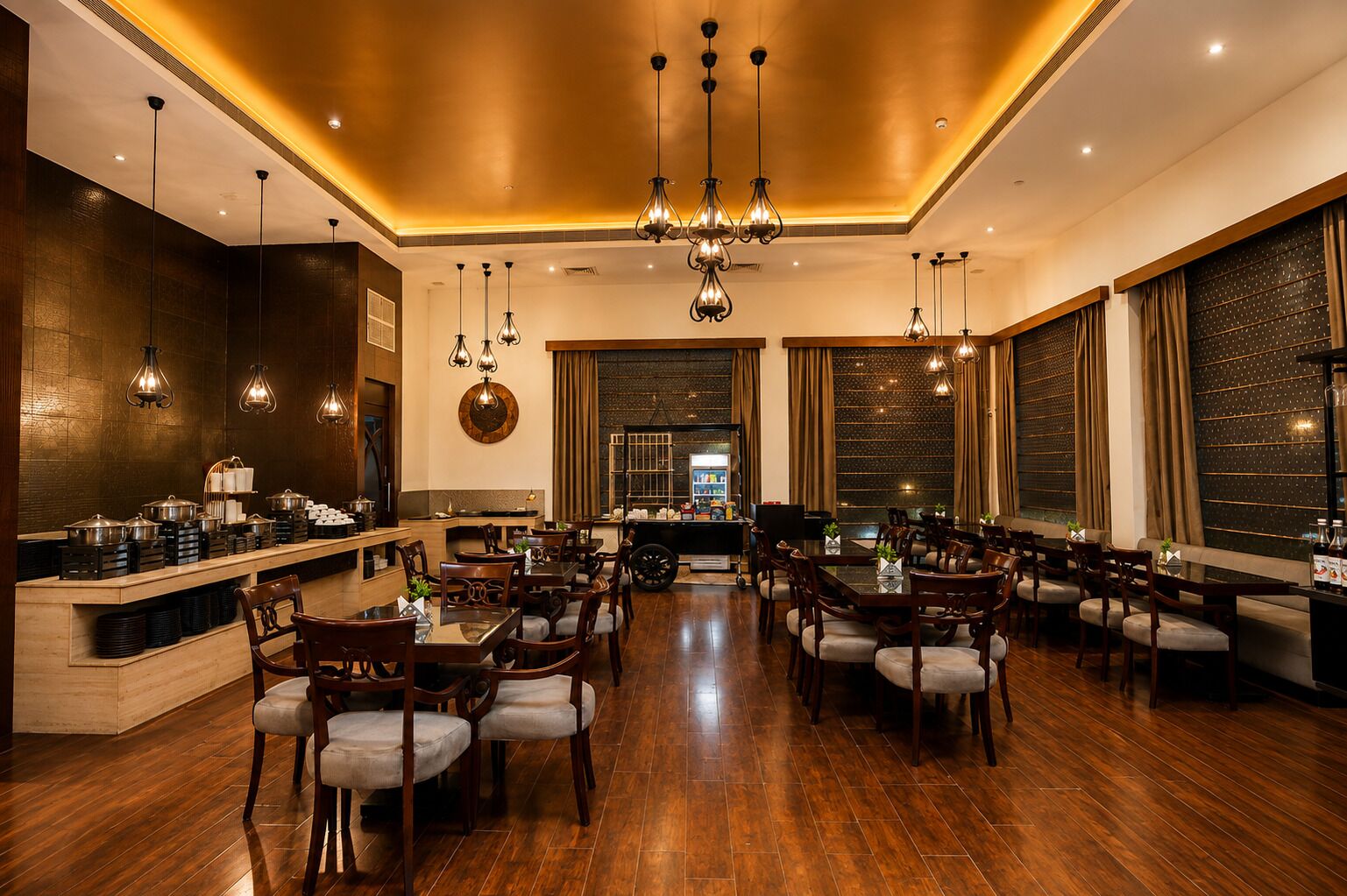 A spacious dining area with wooden flooring, multiple dining tables, and chairs.