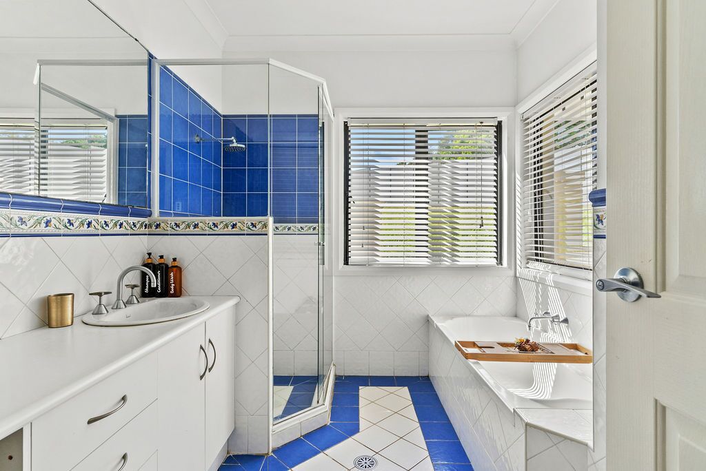 A bathroom with a shower, sink, and bathtub.
