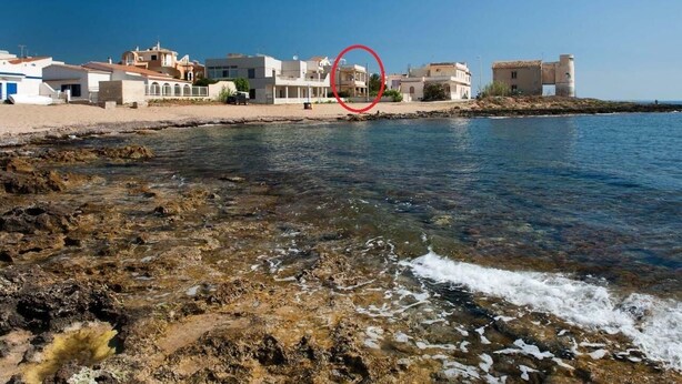 A coastal town with buildings along the shore, a clear view of the sea, and rocky terrain near the water. - 2 Bedroom Villa in Calabernardo (Calabernardo)