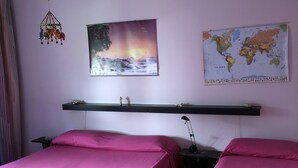 A room with two beds, a world map, a sunset painting, and a hanging lantern. - 2 Bedroom Villa in Calabernardo (Calabernardo)