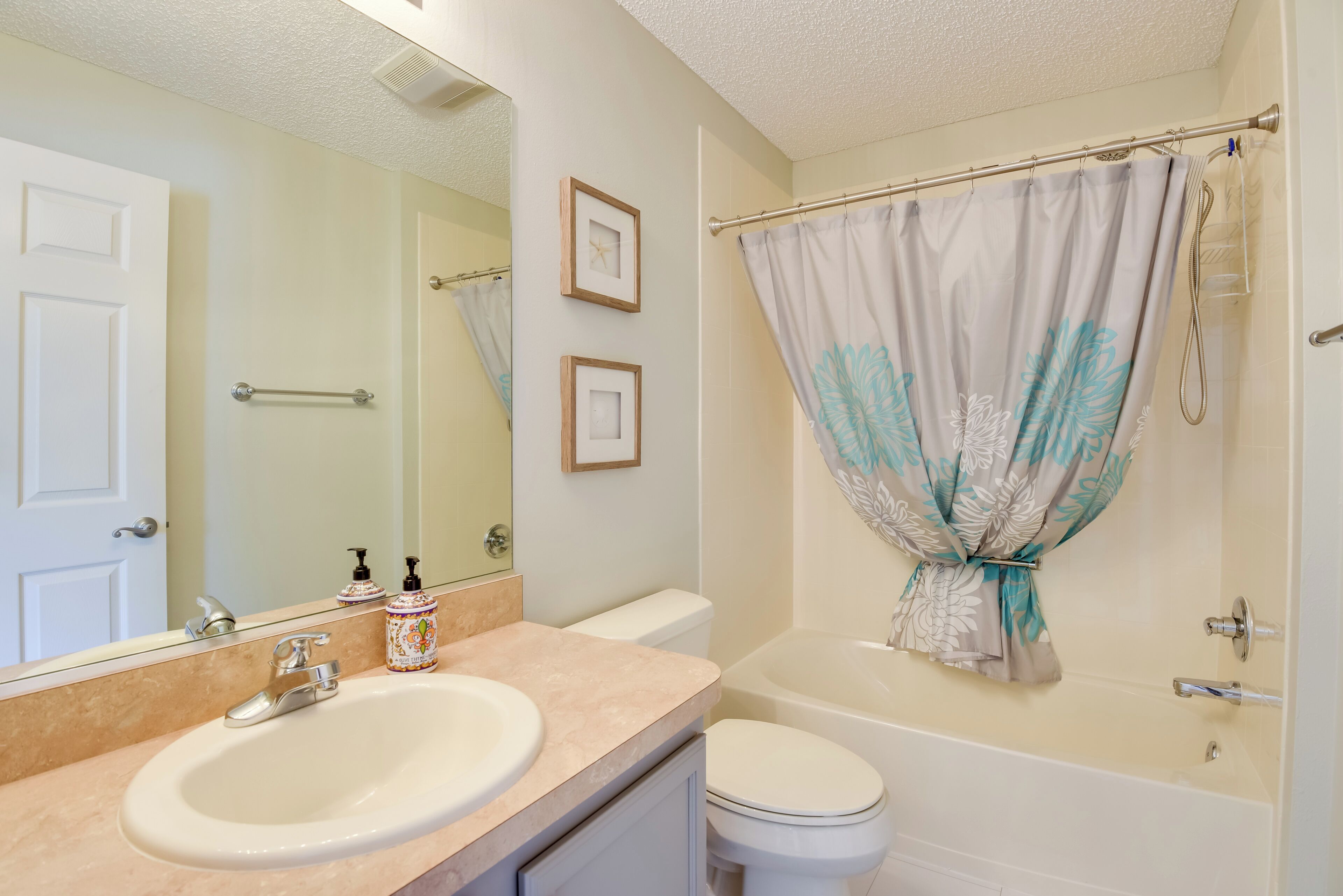 A bathroom with a sink, toilet, and bathtub.