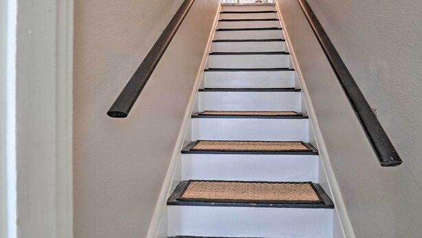 A staircase with white steps and dark handrails, leading to a door at the top. - Spacious Lexington Studio: 2 Miles to Rupp Arena (Lexington)
