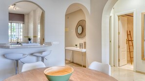 A modern kitchen with a central island, white cabinetry, and a large window. - Beautiful 2-Bedroom Apartment in Estepona with Pool and Terrace (Estepona)