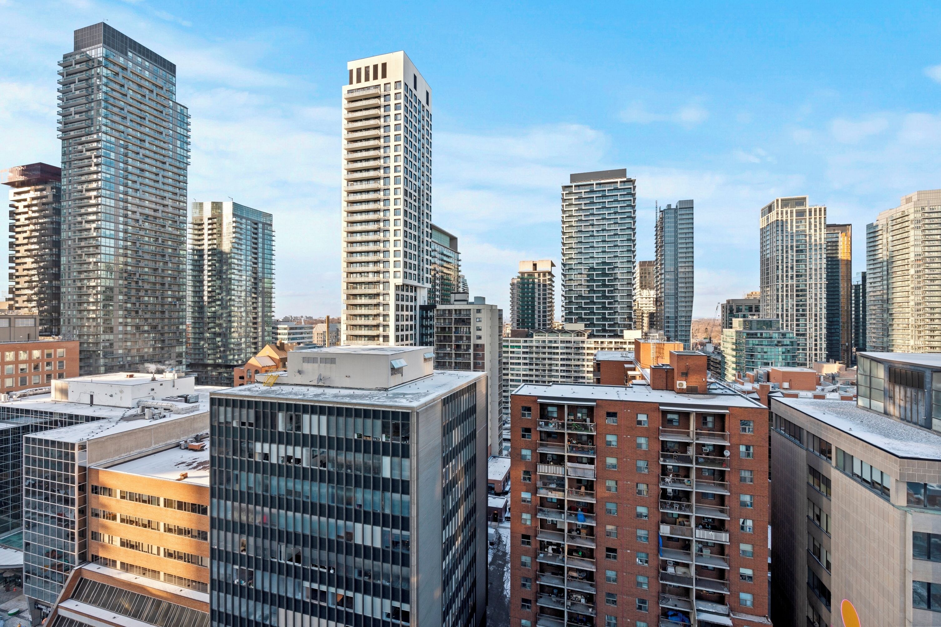 A cityscape with high-rise buildings, including a mix of residential and commercial structures.