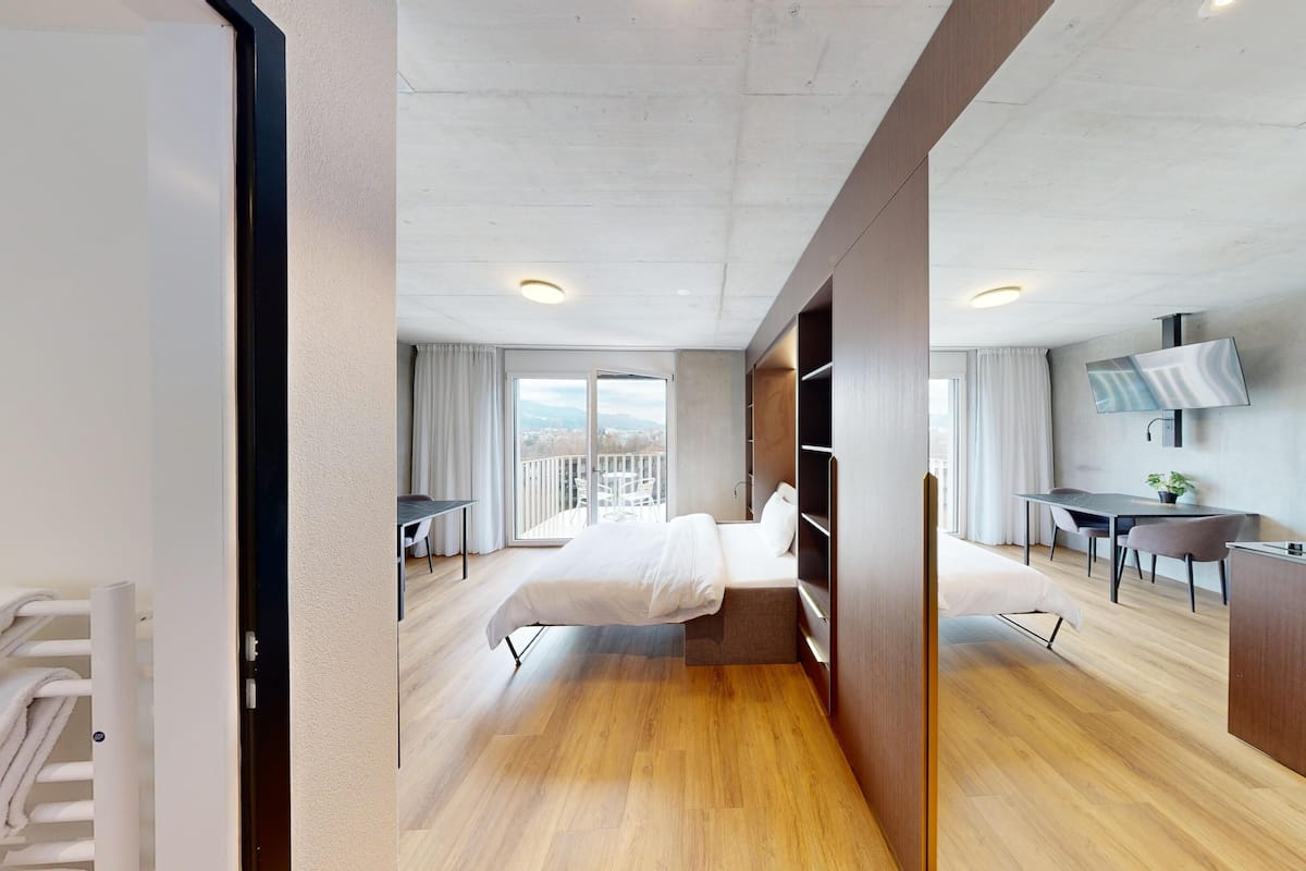 Premium bedding, desk, laptop workspace, soundproofing