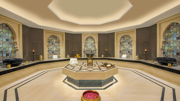 A spacious lobby with a central fountain, ornate stained glass windows, and a decorative bowl on the floor. - Taj Gandhinagar Resort & Spa (Mansa)