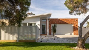 A two-story house with a white exterior and a brick section on the right. - Casa Bella on Beach in Cowes (Cowes)