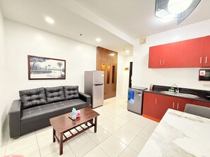 City Condo, 1 Queen Bed, City View | Living area | 55-inch TV with digital channels