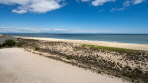 A beach view with a house and a fence. - Beautiful two bedroom, 2 bath condo in desirable North OC with great views! (Ocean City)