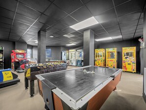 Enjoy games and entertainment in this vibrant indoor space featuring a foosball table and arcade games.