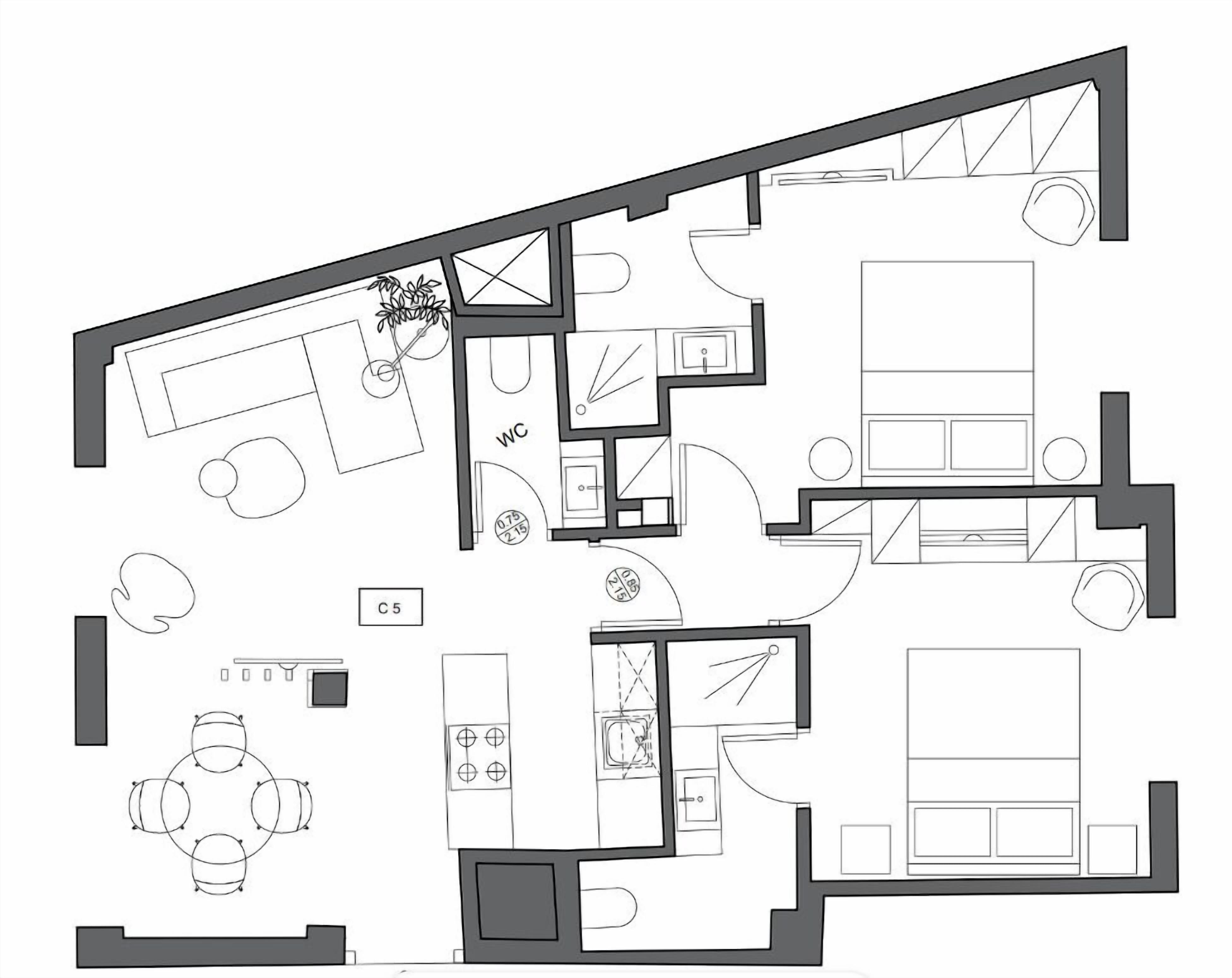 A floor plan of a hotel room with a kitchenette, a bathroom, a living area, and a dining area.