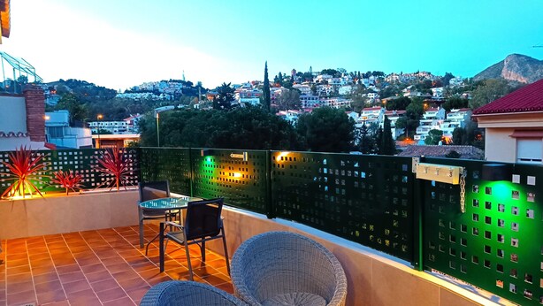 A terrace with wicker furniture and a view of a hillside town. - D-1 Studio with terrace and views (Malaga)