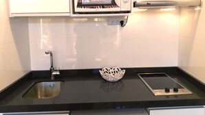 A kitchen with a built-in microwave, a sink, and a stove. - D-1 Studio with terrace and views (Malaga)