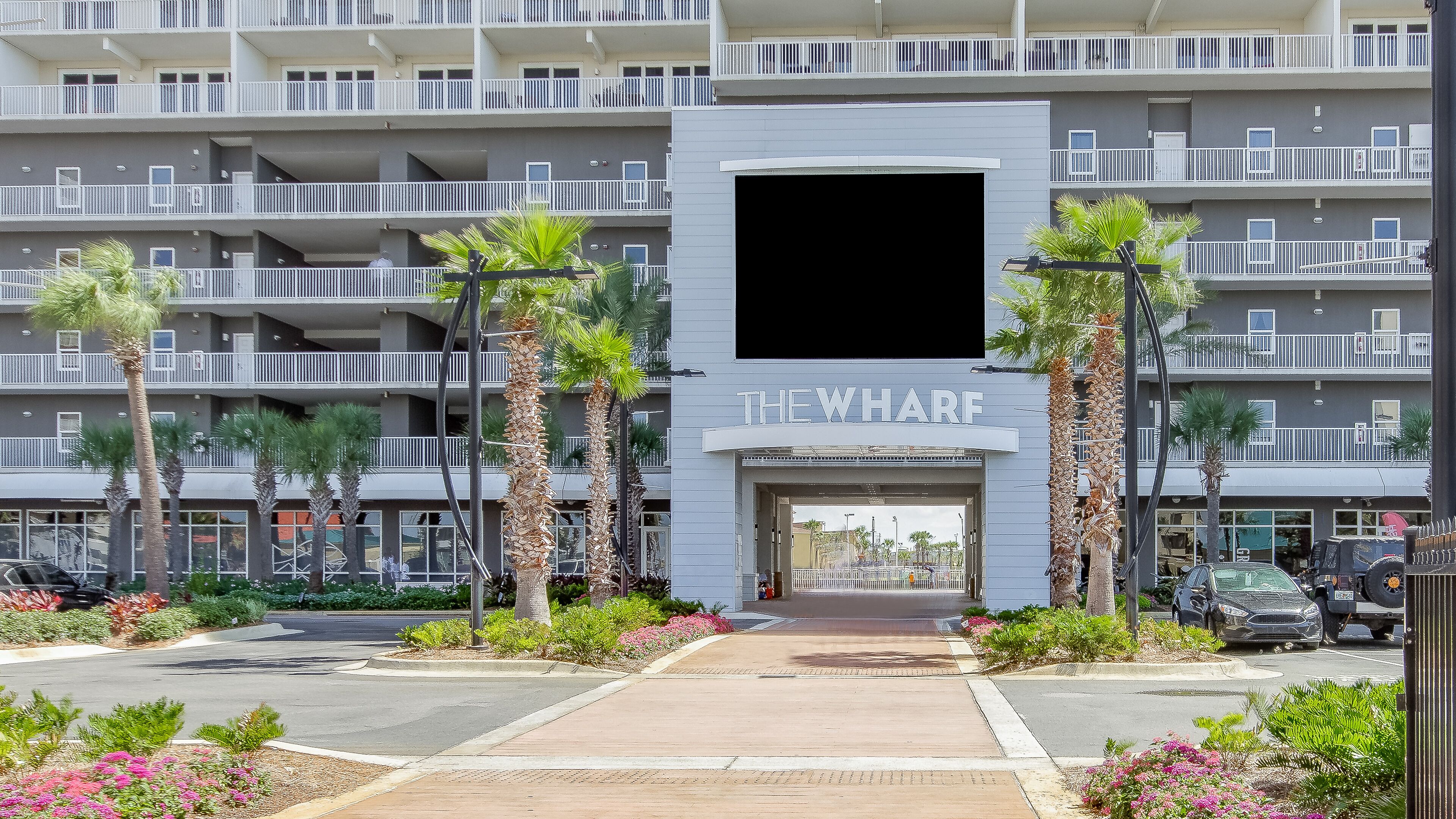A hotel entrance with a sign reading "THE WHARF".