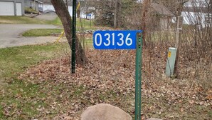 A residential street sign with 'End Rogers 22 Townshed' and '03136' indicating a street number. - Cabin Getaway! (Remer)