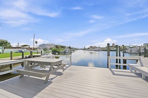 A wooden dock with picnic tables and a calm water body. - Penthouse condo with amazing views! Private 1000 sf balcony (Madeira Beach)