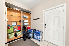 A hotel hallway with a coat check area, storage cabinets, and a white door. - Penthouse condo with amazing views! Private 1000 sf balcony (Madeira Beach)