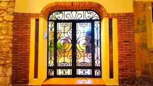A wrought iron gate with a decorative arch and a number plaque above it. - G-3 Studio with patio and mountain views. (Malaga)