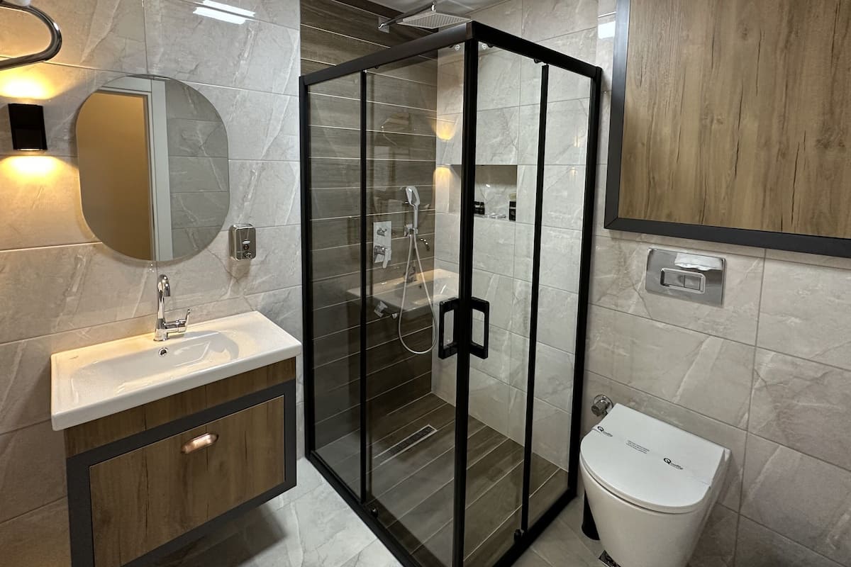 junior suite, multiple beds | bathroom | shower, free toiletries, hair dryer, slippers