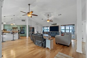 Relax in this stylish living area with a sofa, dining table, and kitchenette.
