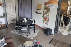Cozy living space with a round dining table and comfortable seating for four.
