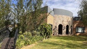 A building with a stone facade, a brick section, and a curved roof.
