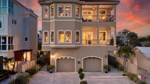A two-story house with a garage, a balcony, and a driveway. - Stunning 3 Bedroom / 2.5 Bath Condo Steps from Siesta Key Beach! (Siesta Key)