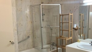 A bathroom with a glass-enclosed shower, a white sink, and a wooden shelf. - 200m from ski lifts, 7th floor, view mountain, balcony, tv, ski locker, 69m², Brides Les Bains (Brides-les-Bains)