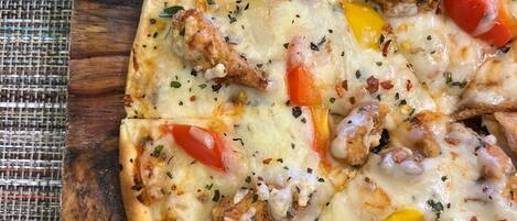 Una pizza con diversos ingredientes sobre una tabla de madera.