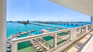 A balcony with a view of a marina and a bridge. - Bayfront Miami Condo w/ Resort Perks & Ocean Views (Miami)
