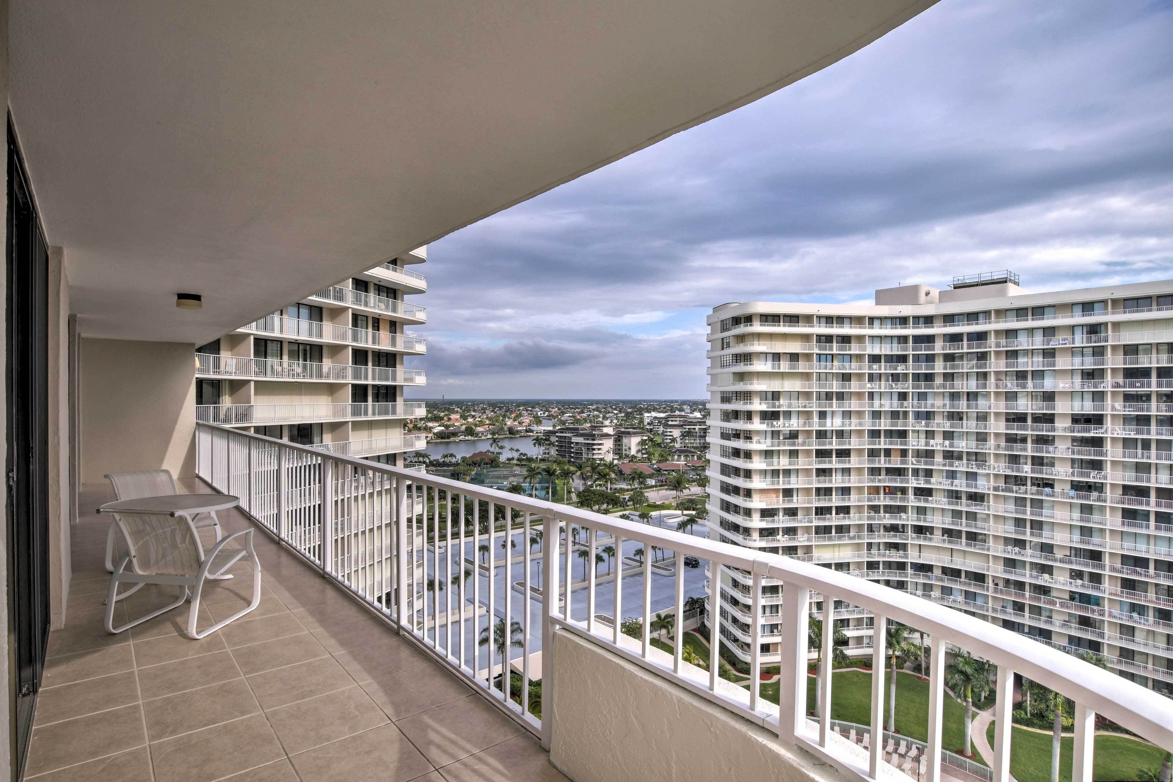 Ein Balkon mit Blick auf eine Stadtlandschaft, darunter Hochhäuser und ein Gewässer.