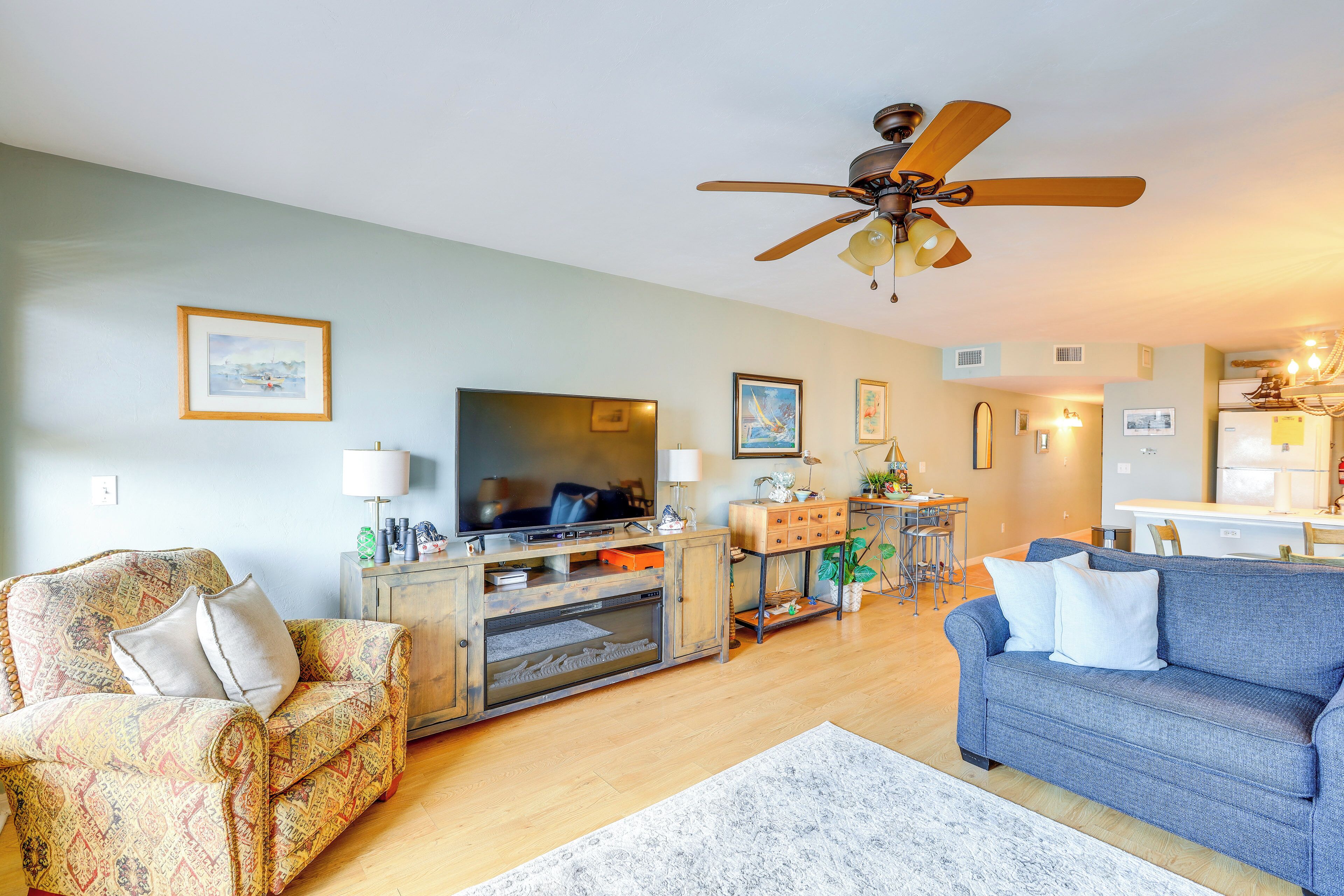 A living room with a sofa, TV, and entertainment center.
