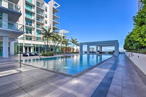A modern hotel with a pool area, palm trees, and a view of the city skyline. - Chic Miami Condo w/ Pool, 6 Mi to South Beach (Miami)