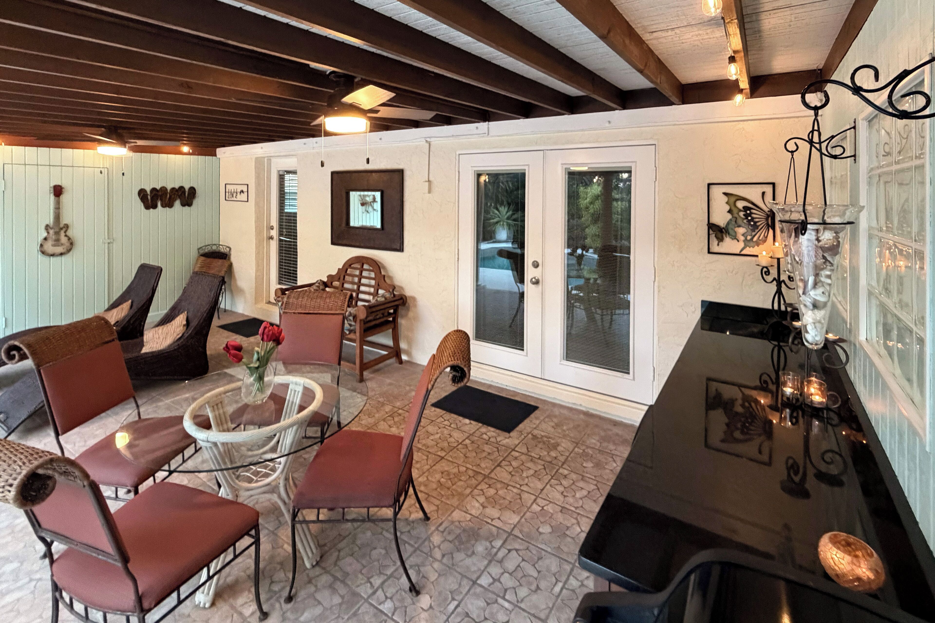 A cozy interior with a dining area, seating, and a guitar wall art.