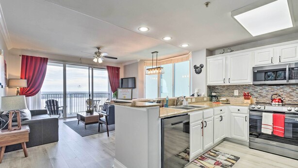 A modern kitchen with white cabinets, stainless steel appliances, and a large island. - Family Resort Condo w/ 2 Pools: 1 Mi to Disney! (Orlando)