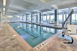 An indoor swimming pool with clear lane markings, a lifeguard chair, and a tiled floor with a 3 ft 6 in depth marker. - Community Perks! Dreamy Daytona Studio (Daytona Beach)