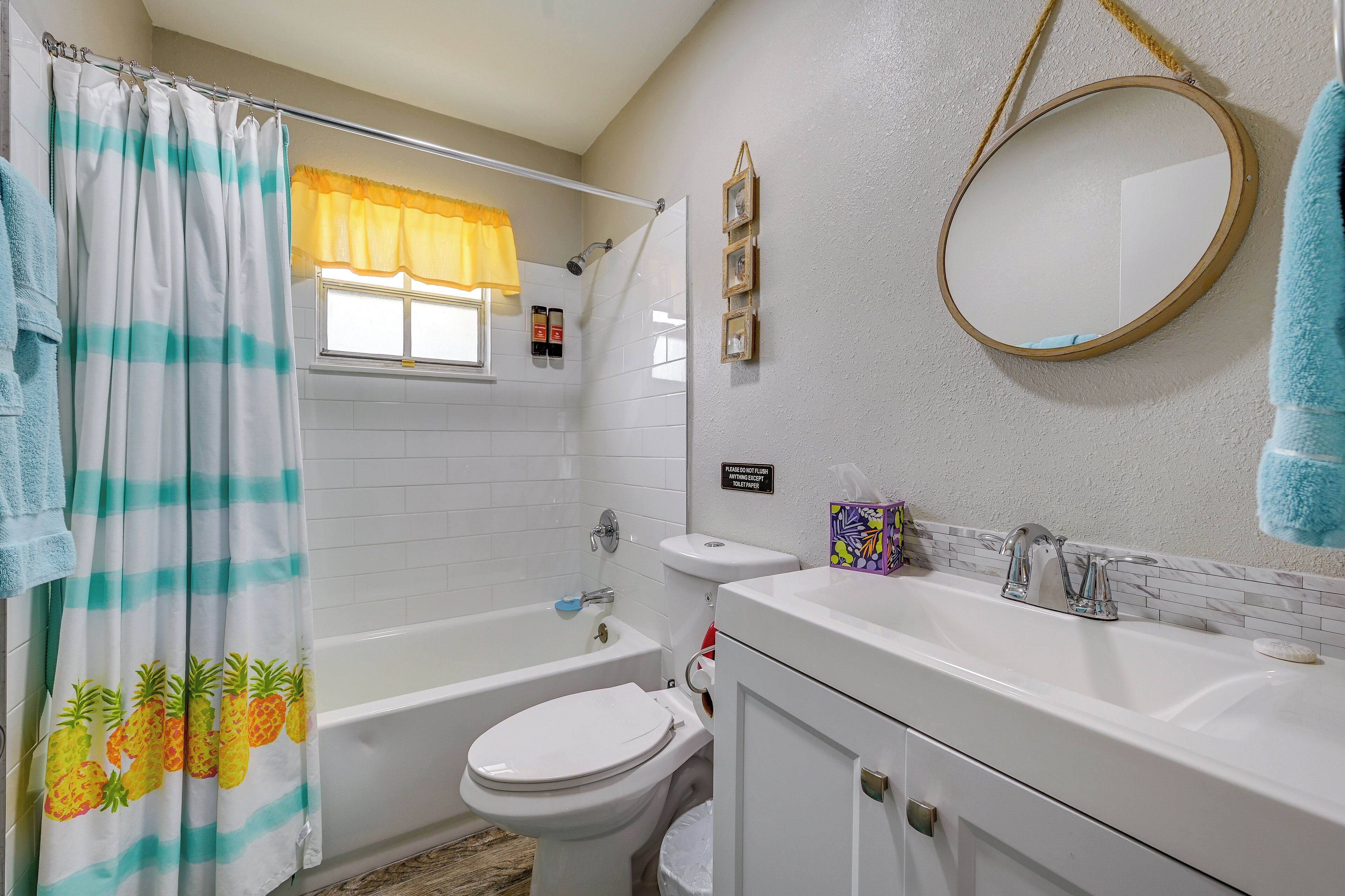 A bathroom with a shower, toilet, and sink.