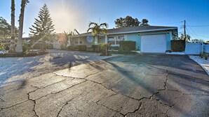 A residential house with a garage, palm trees, and a driveway. - Lush Seminole Surf Inn w/ Backyard Fire Pit! (Seminole)