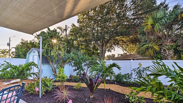 A garden with various plants and a small shed. - Lush Seminole Surf Inn w/ Backyard Fire Pit! (Seminole)
